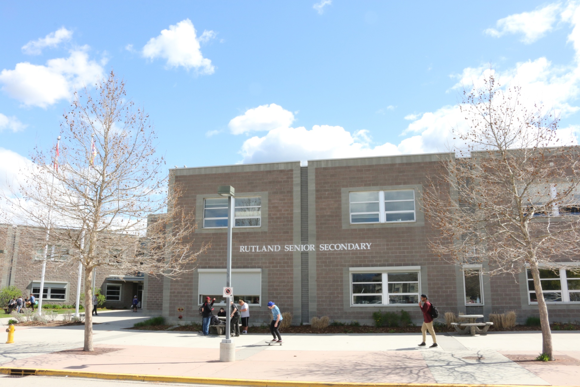 Front of school showing Rutland Senior Secondary and some students walking by